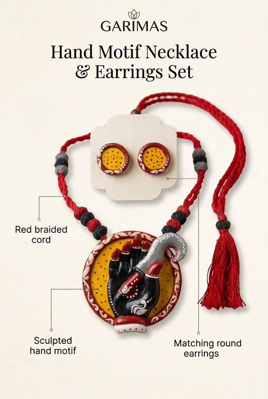 GARIMAS necklace set infographic highlighting the sculpted hand pendant, red braided cord and round earrings.