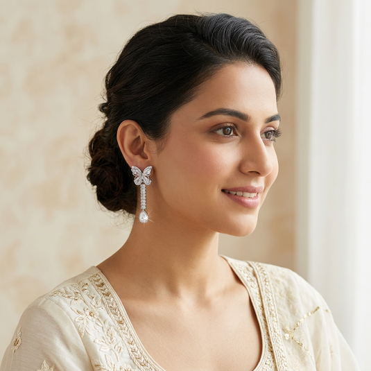 GARIMAS handmade Turkish butterfly drop earrings shown on a model.