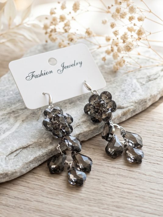 Pair of smoky grey floral drop earrings with faceted teardrop accents and silver-tone hooks