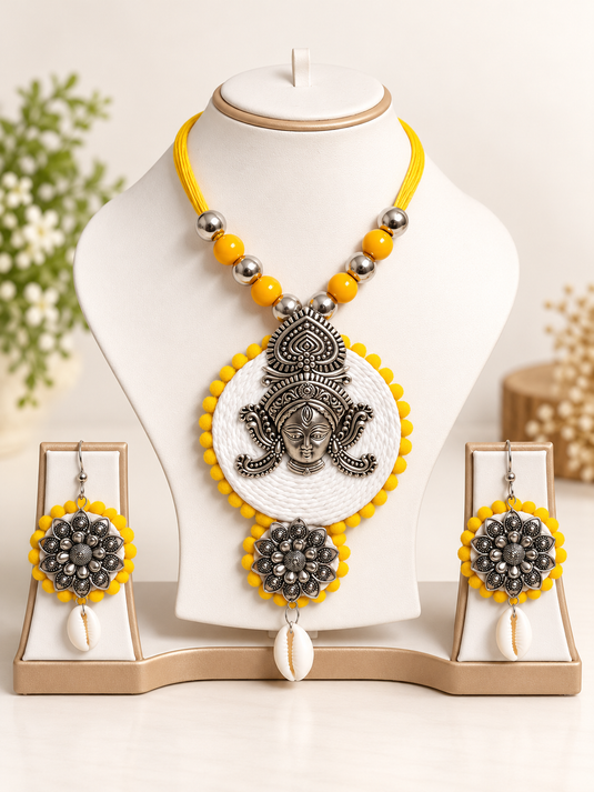 GARIMAS yellow bead necklace set with white woven-look pendant and matching earrings