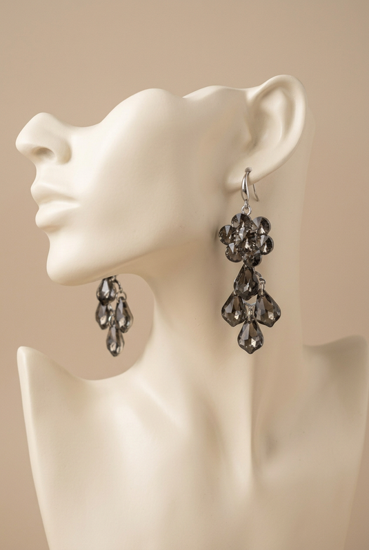 Smoky grey floral drop earrings displayed on an ivory mannequin head