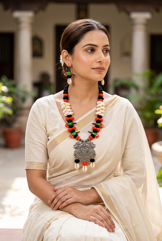 Indian woman wearing GARIMAS bird charm necklace and matching earrings