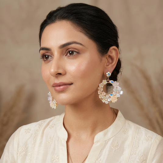 GARIMAS pastel floral Turkish statement earrings worn with an ivory festive outfit.