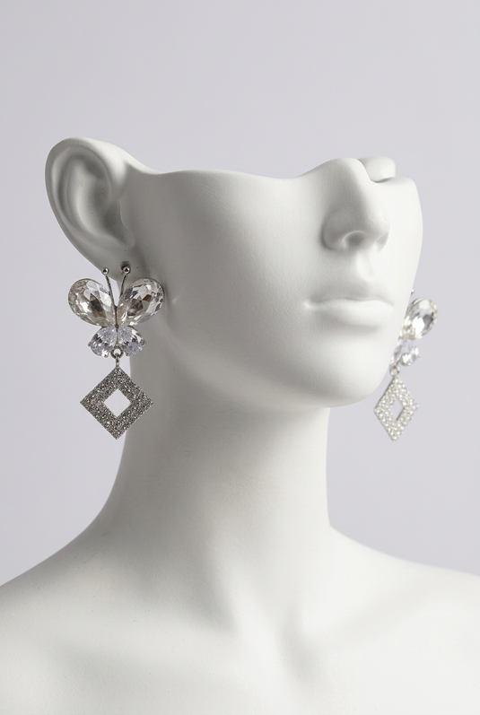 Silver butterfly earrings on white mannequin