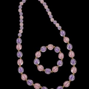Necklace with pink and purple beads on a light gray background