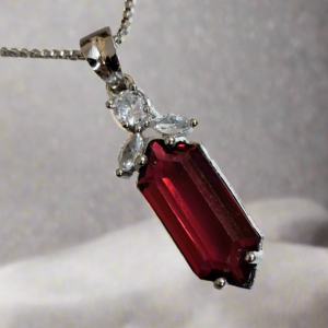 Elegant pendant set with red ruby and CZ stones on a silver-plated chain by Garimas.